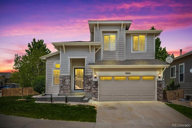 10685 Cherrybrook Cir, Highlands Ranch, CO 80126 - view of front facade featuring an attached garage, driveway, and stone siding