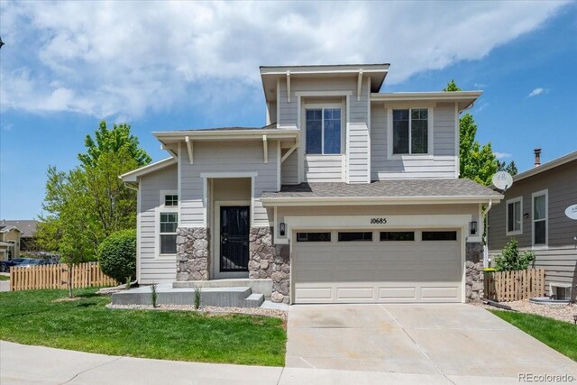 10685 Cherrybrook Cir, Highlands Ranch, CO 80126 - prairie-style house with an attached garage, concrete driveway, stone siding, and roof with shingles
