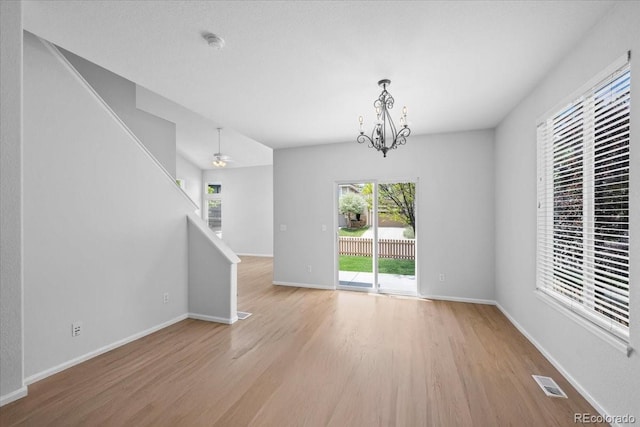 10685 Cherrybrook Cir, Highlands Ranch, CO 80126 - unfurnished room featuring wood finished floors, stairway, a chandelier, a smoke detector, and baseboards