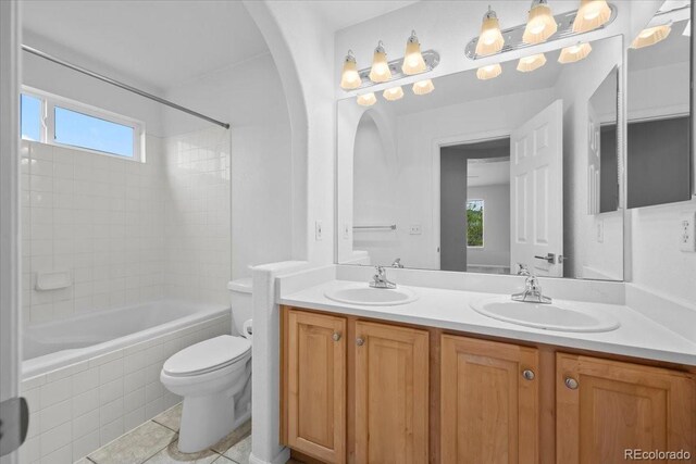 10685 Cherrybrook Cir, Highlands Ranch, CO 80126 - bathroom featuring double vanity, toilet, healthy amount of natural light, and washtub / shower combination
