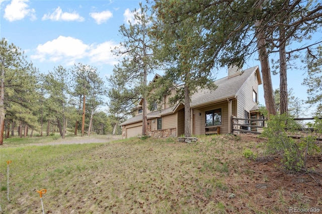 4992 White House Trl, Evergreen, CO 80439 - view of side of home featuring a garage, a chimney, and a shingled roof