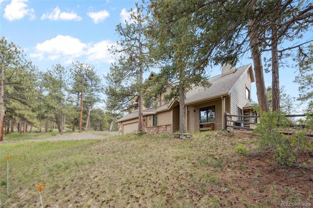 4992 White House Trl, Evergreen, CO 80439 - view of side of property with a garage, a chimney, and a shingled roof