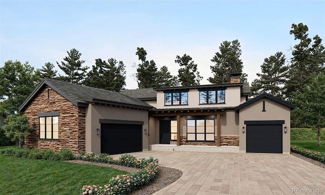 view of front of property with a front yard and a garage