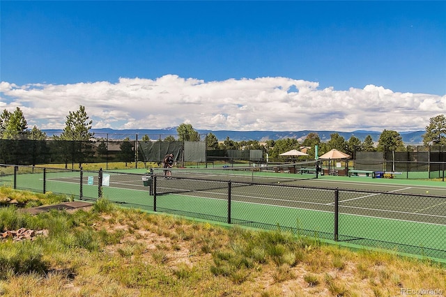 view of tennis court with a mountain view