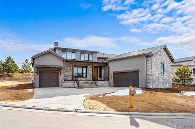 view of front of property with a garage, stone siding, concrete driveway, and stucco siding