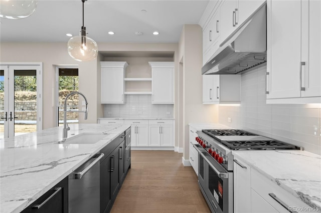 kitchen with under cabinet range hood, a sink, white cabinetry, appliances with stainless steel finishes, and open shelves