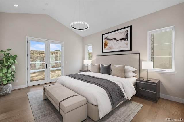 bedroom featuring wood finished floors, baseboards, vaulted ceiling, access to outside, and french doors