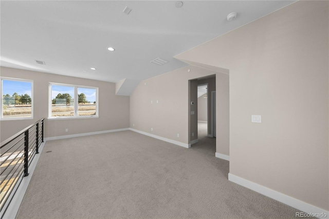 additional living space with recessed lighting, light carpet, visible vents, and baseboards