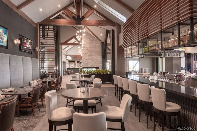 dining area featuring high vaulted ceiling and beam ceiling