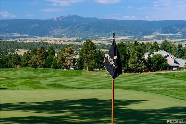 view of community with a mountain view and golf course view