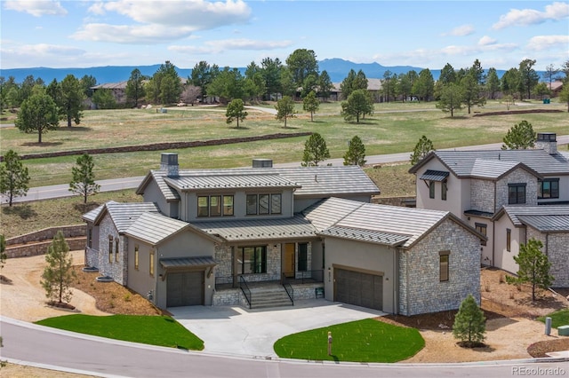 8014 Trinity Peak Ln, Castle Rock, CO 80108 - view of front of house with stucco siding, stone siding, a porch, concrete driveway, and a mountain view