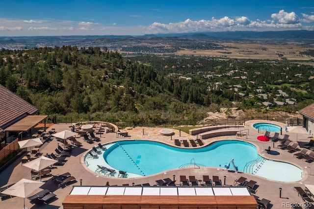 8014 Trinity Peak Ln, Castle Rock, CO 80108 - community pool featuring a patio, fence, and a view of trees