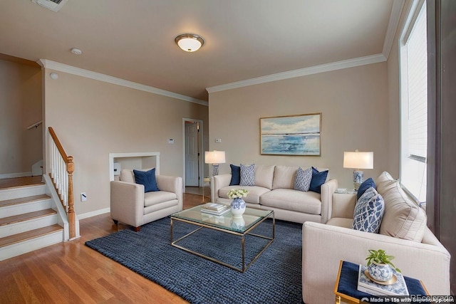 3515 W Walsh Pl, Denver, CO 80219 - living room featuring ornamental molding, healthy amount of natural light, wood finished floors, stairs, and baseboards