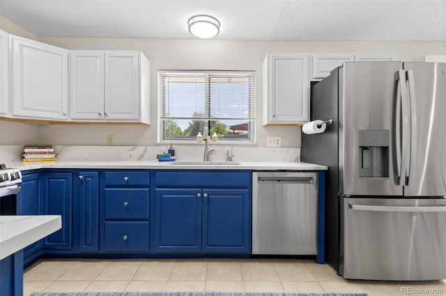 1204 Catalpa Cir, Broomfield, CO 80020 - kitchen featuring stainless steel appliances, white cabinetry, light countertops, and blue cabinets