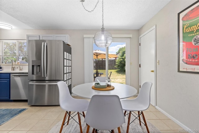 1204 Catalpa Cir, Broomfield, CO 80020 - dining area with a textured ceiling, light tile patterned floors, and plenty of natural light