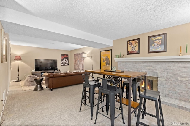 1204 Catalpa Cir, Broomfield, CO 80020 - dining room featuring carpet flooring, a fireplace, and a textured ceiling
