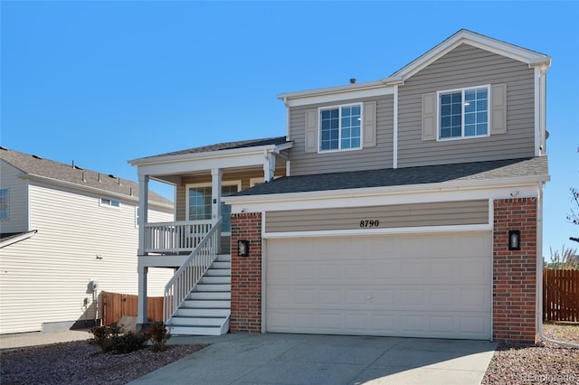 view of front facade with brick siding, fence, stairway, concrete driveway, and a garage