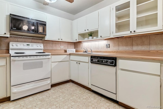 kitchen with white appliances, ceiling fan, white cabinetry, and tasteful backsplash