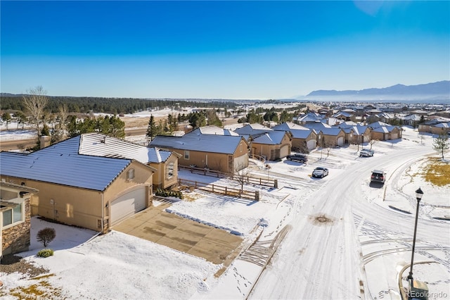 snowy aerial view featuring a mountain view