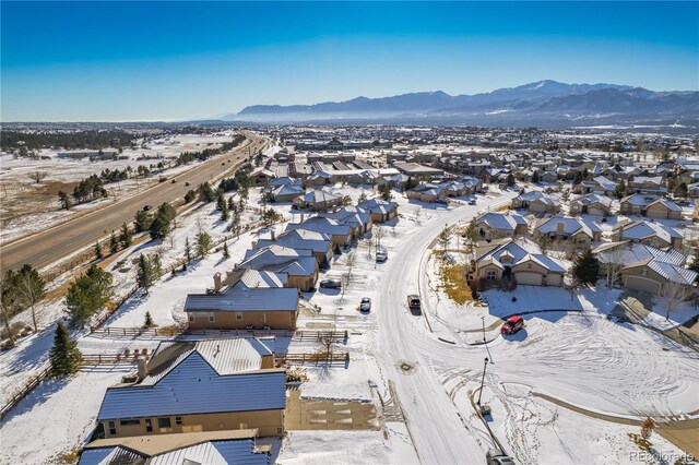 snowy aerial view featuring a mountain view