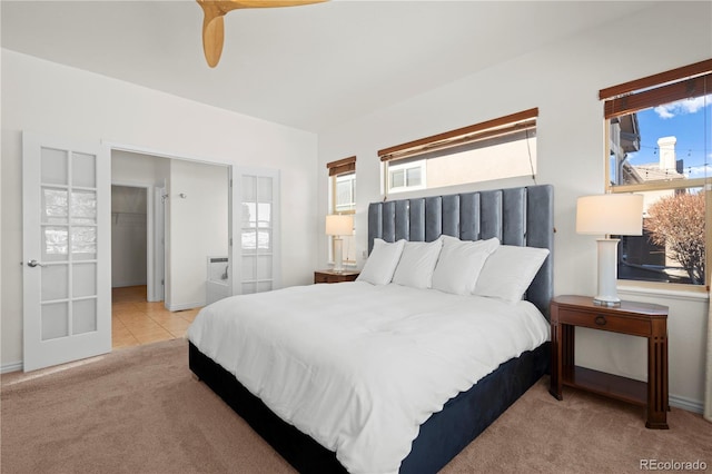 carpeted bedroom featuring ceiling fan and a spacious closet