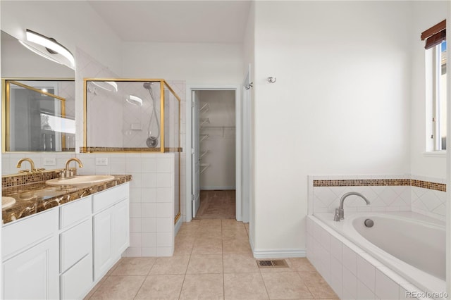 bathroom featuring tile patterned floors, vanity, and plus walk in shower