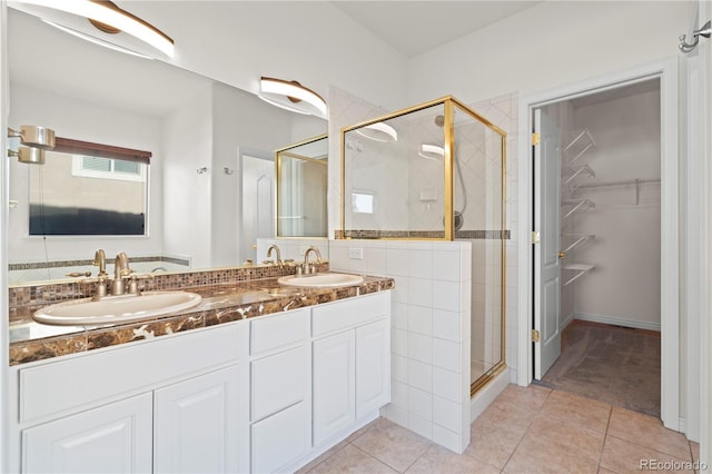 bathroom with tile patterned floors, vanity, and an enclosed shower