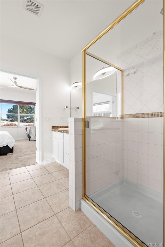 bathroom with tile patterned floors, vanity, and an enclosed shower