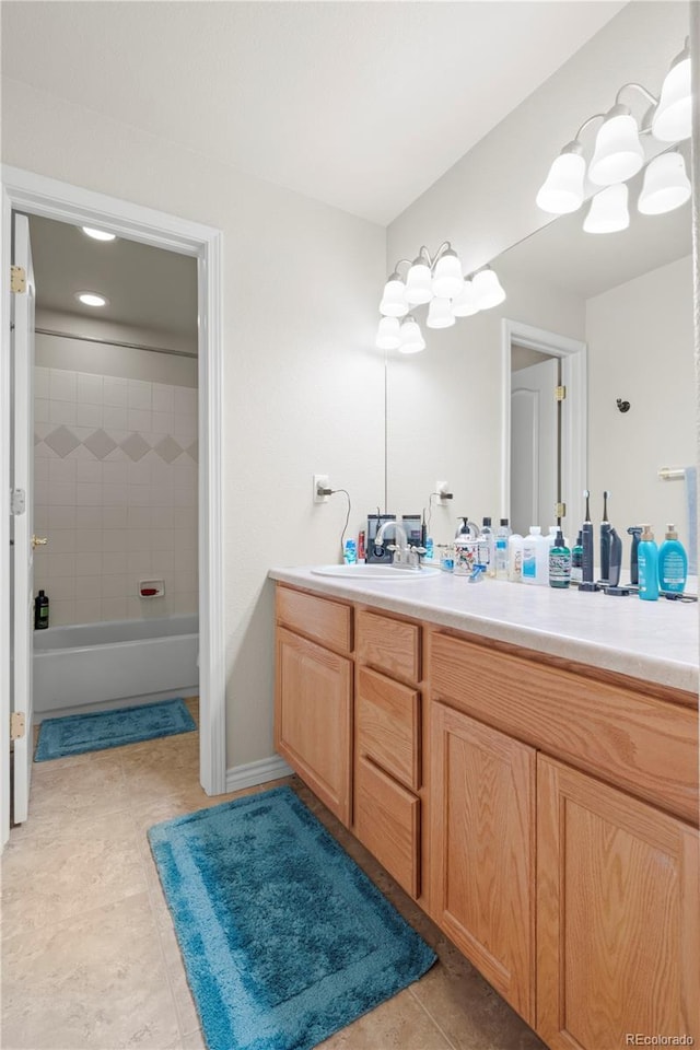 bathroom with vanity, tiled shower / bath combo, a chandelier, and tile patterned flooring