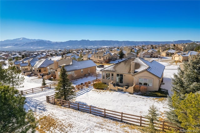 snowy aerial view featuring a mountain view