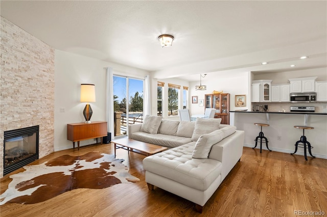 2663 Cinnabar Rd, Colorado Springs, CO 80921 - living room with recessed lighting, a stone fireplace, and wood finished floors