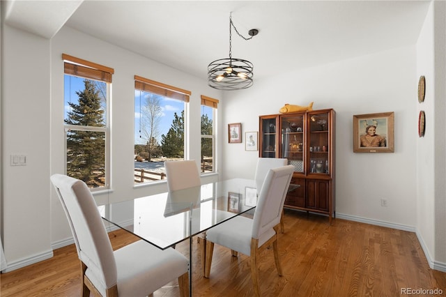 2663 Cinnabar Rd, Colorado Springs, CO 80921 - dining space featuring baseboards, light wood finished floors, and a chandelier