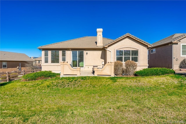 2663 Cinnabar Rd, Colorado Springs, CO 80921 - rear view of property with stucco siding, fence, a yard, and a tiled roof