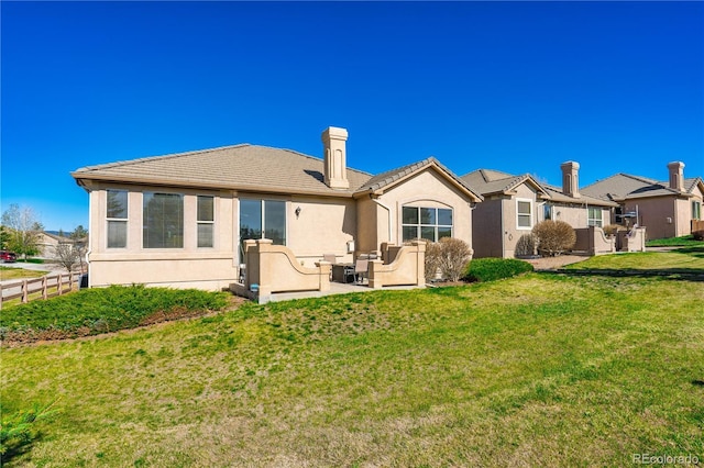 2663 Cinnabar Rd, Colorado Springs, CO 80921 - rear view of property featuring fence, stucco siding, outdoor lounge area, a chimney, and a yard