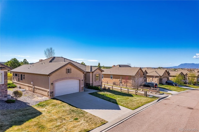 2663 Cinnabar Rd, Colorado Springs, CO 80921 - ranch-style home featuring a front yard, stucco siding, an attached garage, driveway, and a residential view