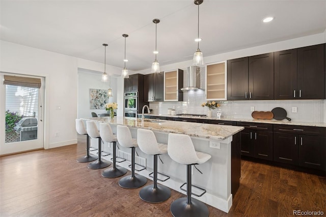 2377 S Humboldt St, Denver, CO 80210 - kitchen featuring wall chimney exhaust hood, stainless steel appliances, dark wood-type flooring, backsplash, and recessed lighting