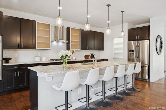 2377 S Humboldt St, Denver, CO 80210 - kitchen with stainless steel appliances, wall chimney exhaust hood, tasteful backsplash, dark wood-style flooring, and recessed lighting