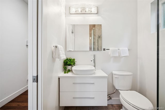 2377 S Humboldt St, Denver, CO 80210 - full bath featuring vanity, tiled shower, and wood finished floors