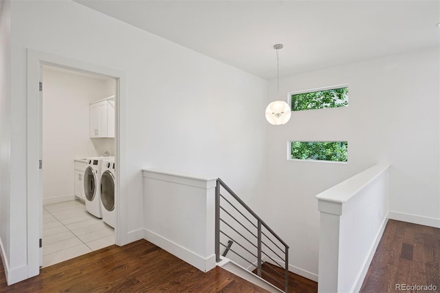 2377 S Humboldt St, Denver, CO 80210 - laundry room featuring cabinet space, washing machine and dryer, and wood finished floors