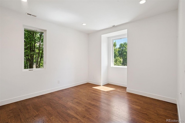 2377 S Humboldt St, Denver, CO 80210 - empty room with healthy amount of natural light, recessed lighting, and wood finished floors