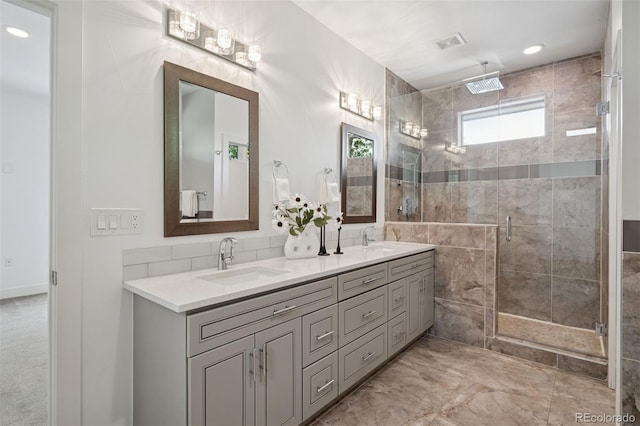 2377 S Humboldt St, Denver, CO 80210 - bathroom with double vanity, a shower stall, and recessed lighting