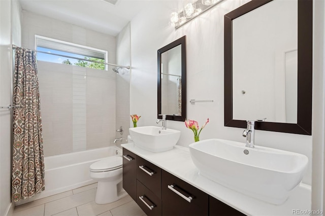 2377 S Humboldt St, Denver, CO 80210 - bathroom featuring double vanity, shower / bath combo with shower curtain, and tile patterned floors