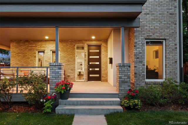 2377 S Humboldt St, Denver, CO 80210 - property entrance featuring a porch and brick siding
