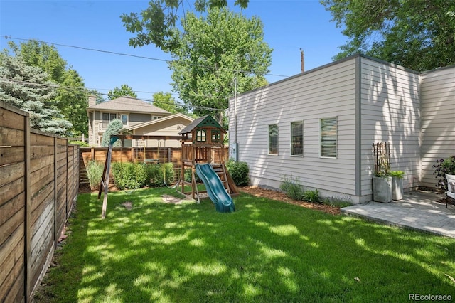 2377 S Humboldt St, Denver, CO 80210 - fenced backyard featuring a playground and a patio area