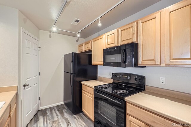 5255 Memphis St Unit 224, Denver, CO 80239 - kitchen featuring black appliances, light brown cabinetry, rail lighting, light wood-style flooring, and light countertops