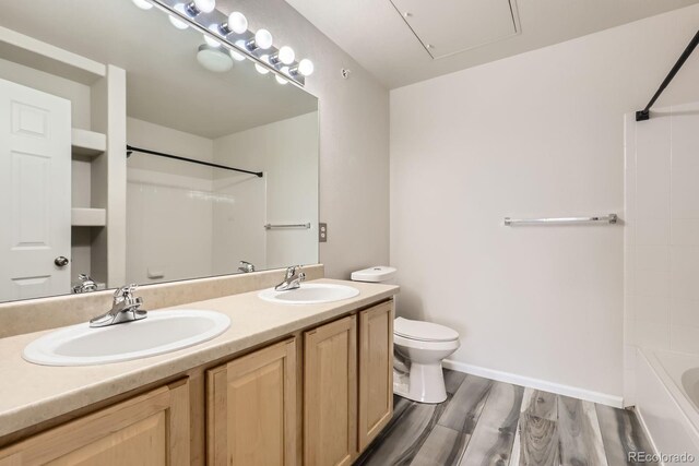 5255 Memphis St Unit 224, Denver, CO 80239 - full bathroom with toilet, double vanity,  shower combination, wood finished floors, and baseboards