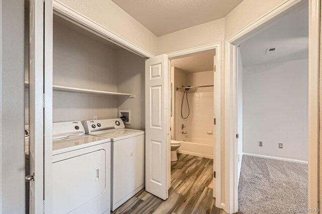 5255 Memphis St Unit 224, Denver, CO 80239 - laundry room with washing machine and clothes dryer, wood finished floors, and baseboards