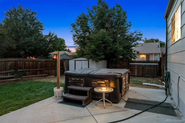 20714 E Buchanan Dr, Aurora, CO 80011 - patio terrace at dusk with a patio, a hot tub, a fenced backyard, and a storage unit