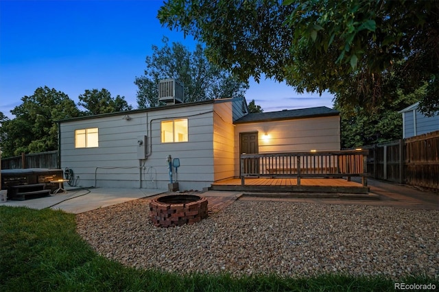 20714 E Buchanan Dr, Aurora, CO 80011 - rear view of property with an outdoor fire pit, a wooden deck, a fenced backyard, and a patio area