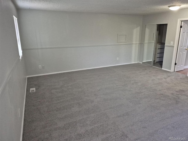16835 E Harvard Pl, Aurora, CO 80013 - carpeted spare room featuring a textured ceiling and baseboards